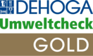 Logo mit den Worten 'DEHOGA' in blauer Schrift, 'Umweltcheck' in grüner Schrift und 'GOLD' in weißer Schrift auf braunem Hintergrund
